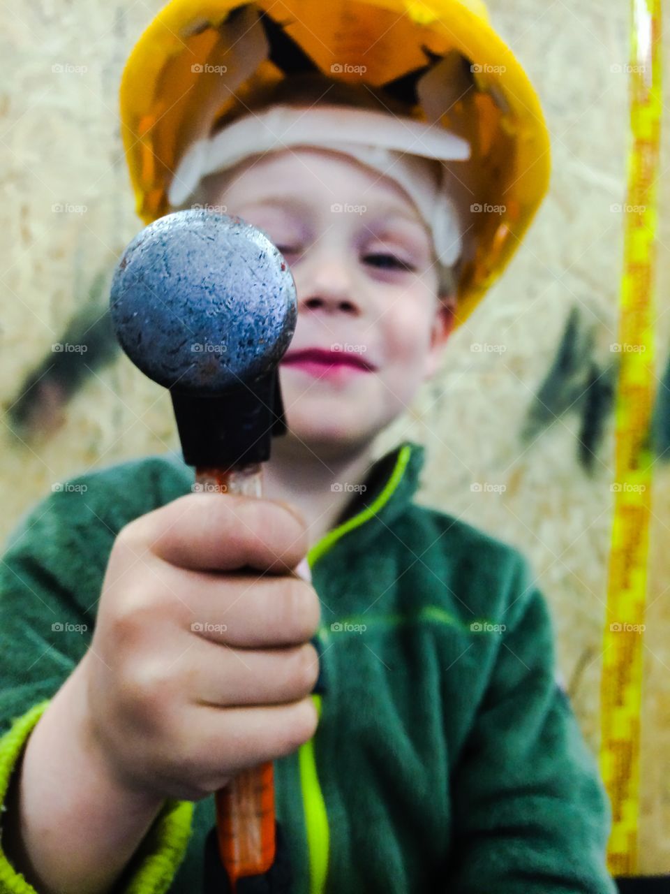 Little worker. Boy uses the hammer at his father work