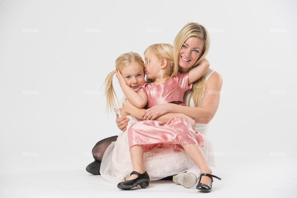 Happy family, mother with her two daughters of 6 and four years old.