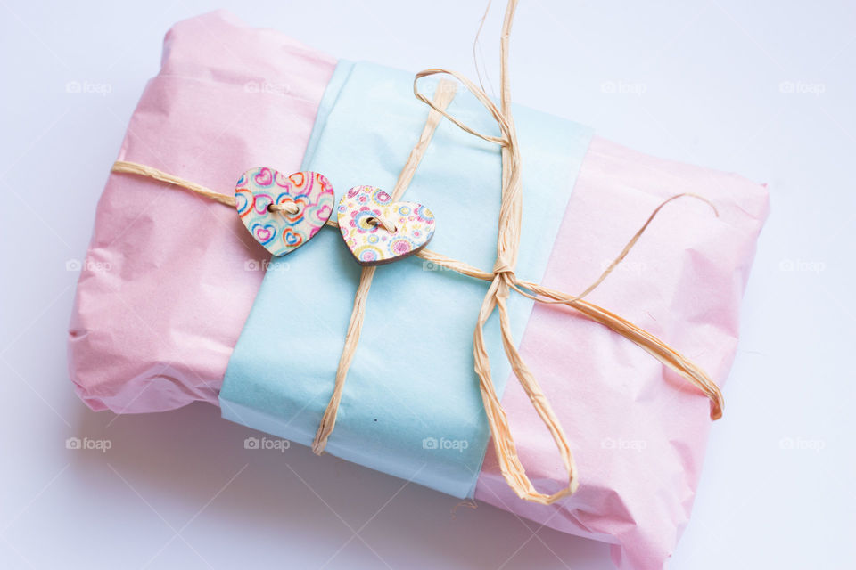 Tissue wrapped pink gift . Rectangular gift wrapped in blue and pink tissue paper