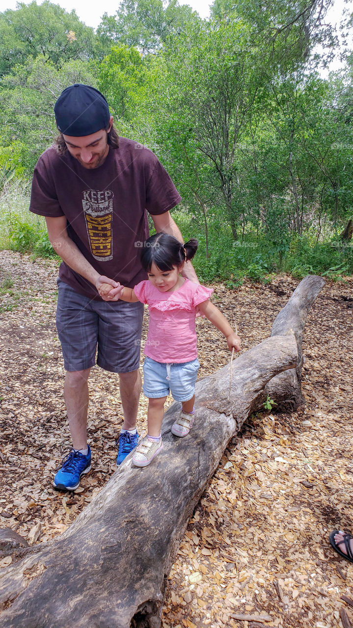 Father daughter fun walking on a log