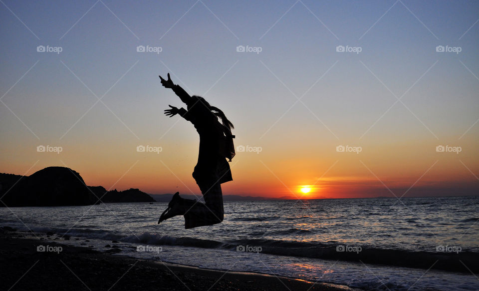 jumping silhouette at the sunrise