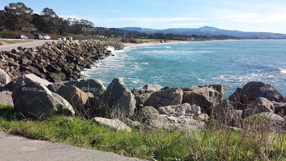 Rocky shore in Half Moon Bay, California overlooking a bright, blue ocean