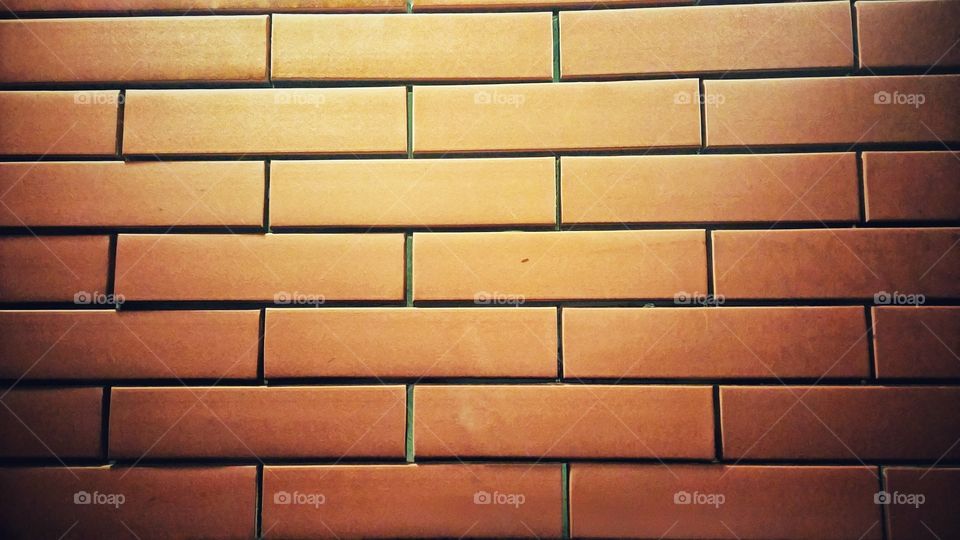 Brick pattern with lighting from lamp on the top.