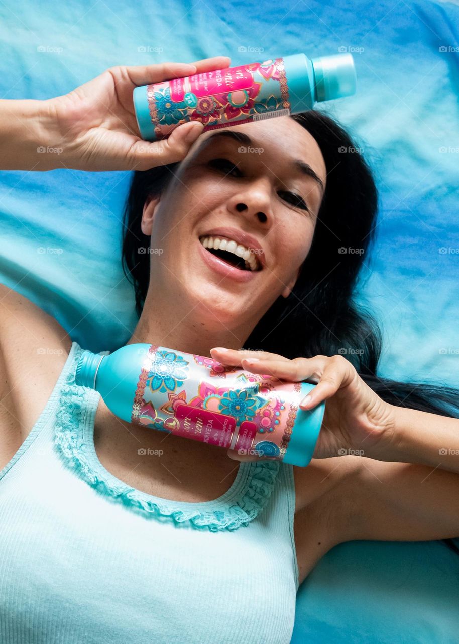 Energetic, Light - Hearted Portrait of Beautiful Smiling Woman with Products