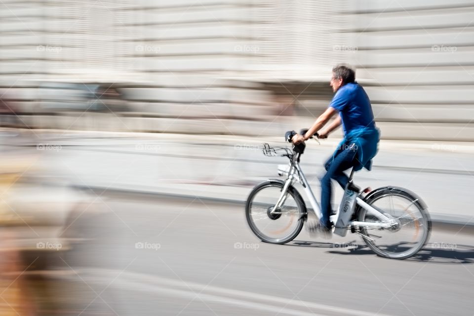 A man riding a bike through the city