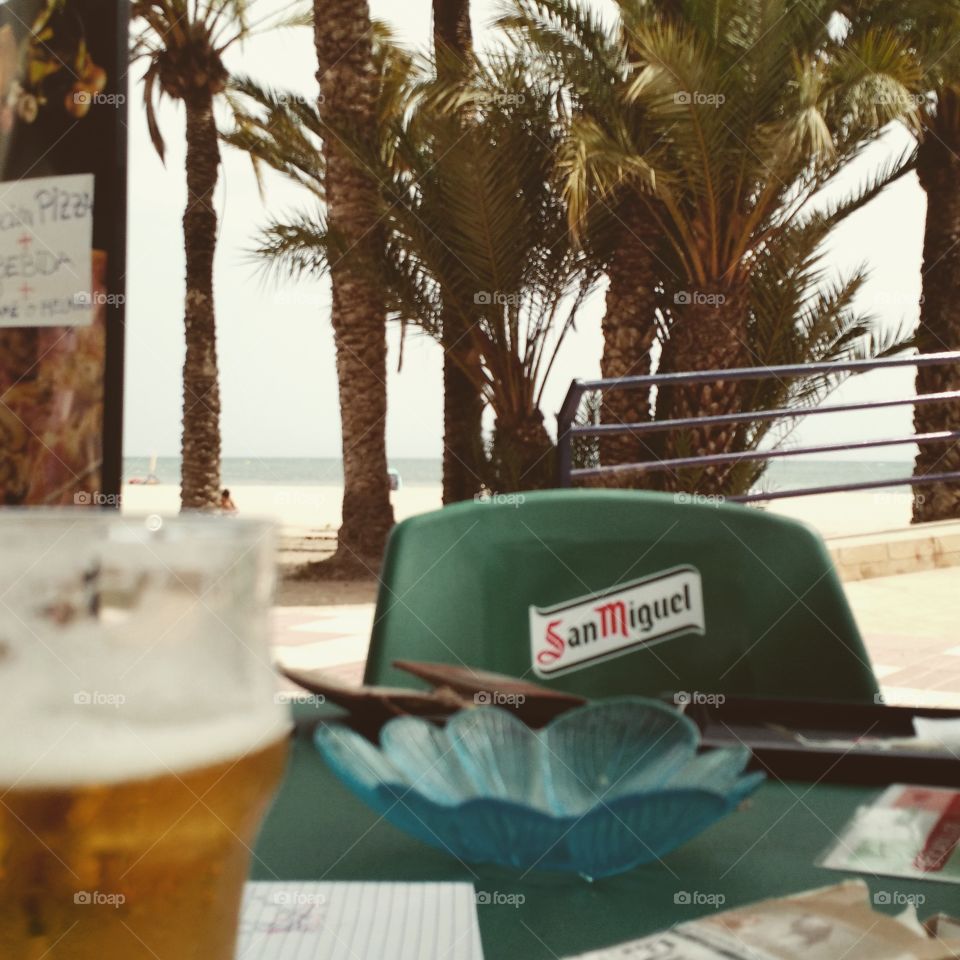 Feeling Melancholic. Having a beer at the beach in Spain Santa pola