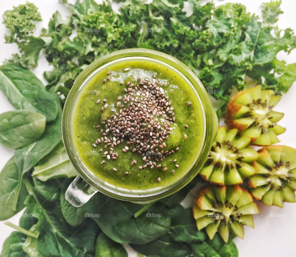 Power packed smoothie with kale spinach mango and kiwi topped with chia seeds 