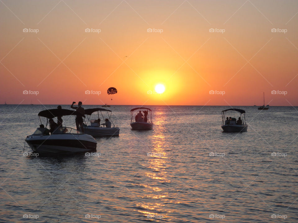 People enjoying boat ride during sunset
