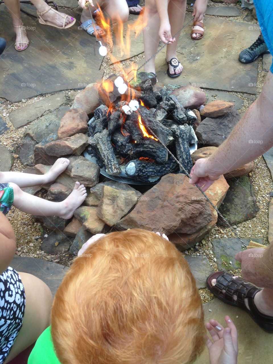 Let's have s'more fun. Kids making s'mores around a fire pit