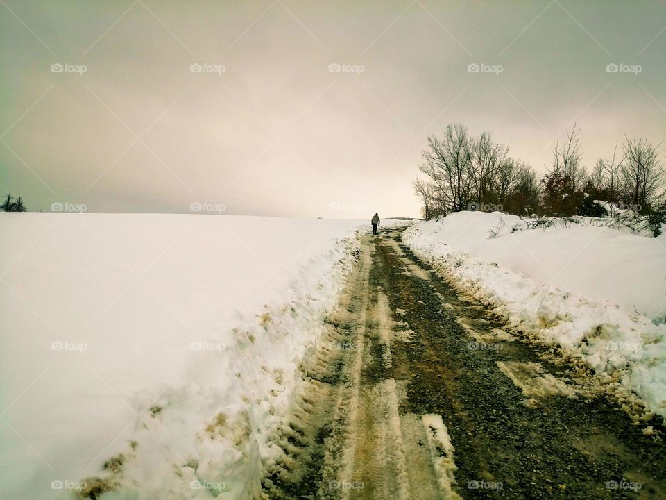 man walking alone in snow