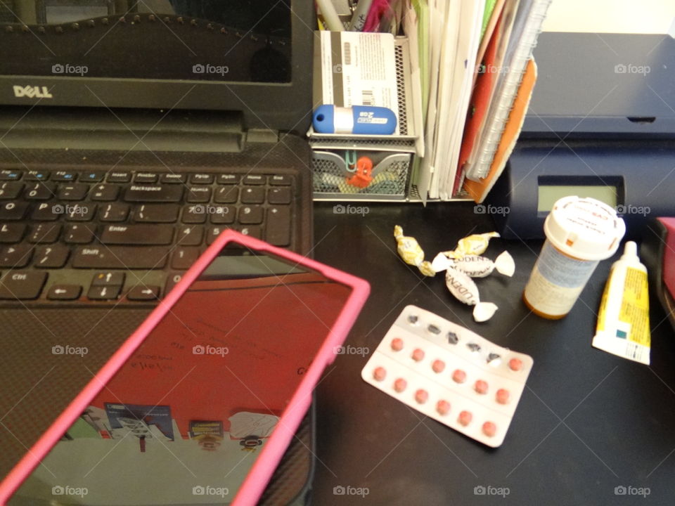 Keep on keepin' on. Desk from above, health items in view, reflection in screen. 