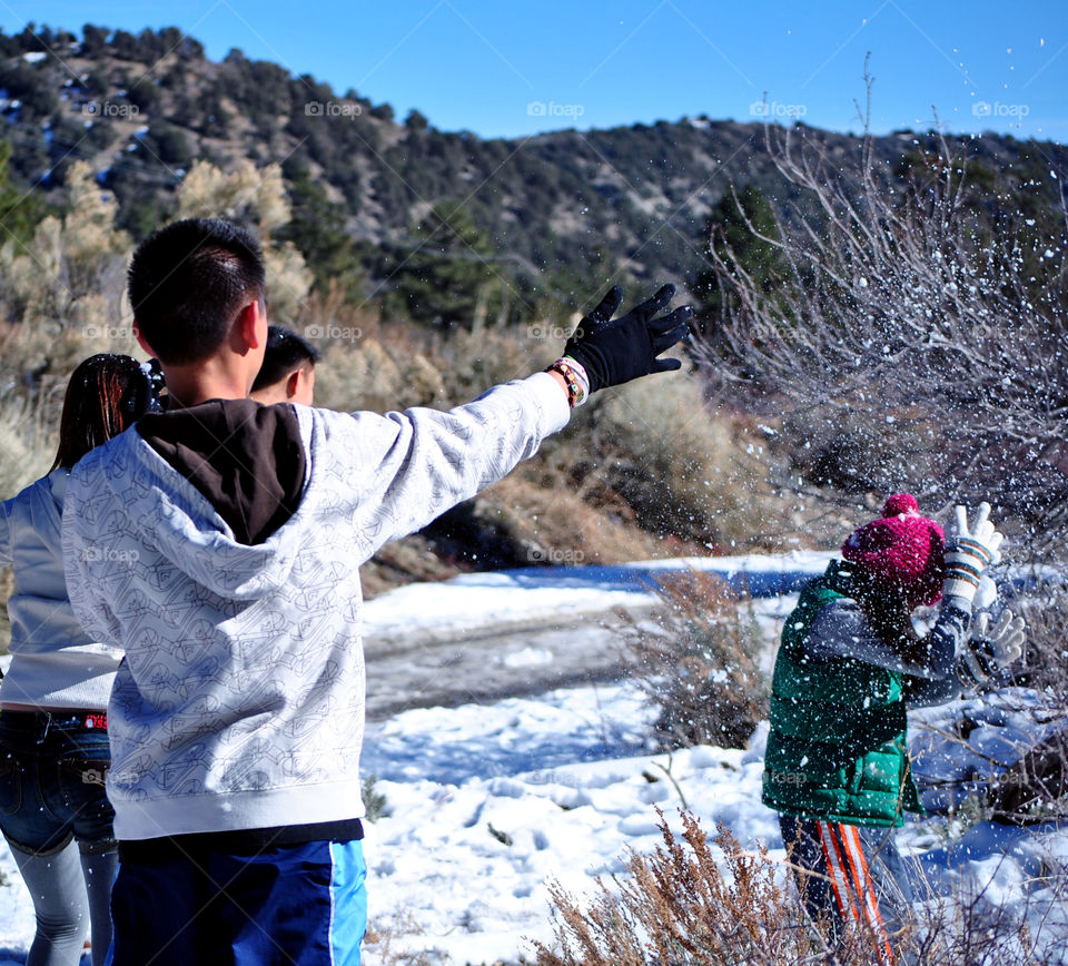 Playing with snow, throwing snow at each other