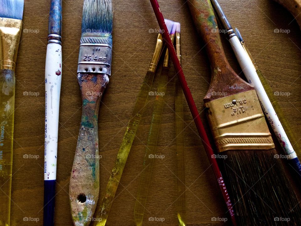 Used paintbrushes on drafting table 