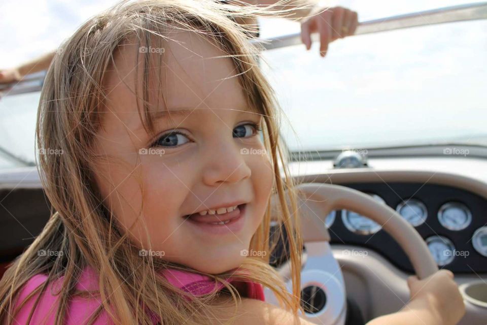Portrait of a happy girl inside car