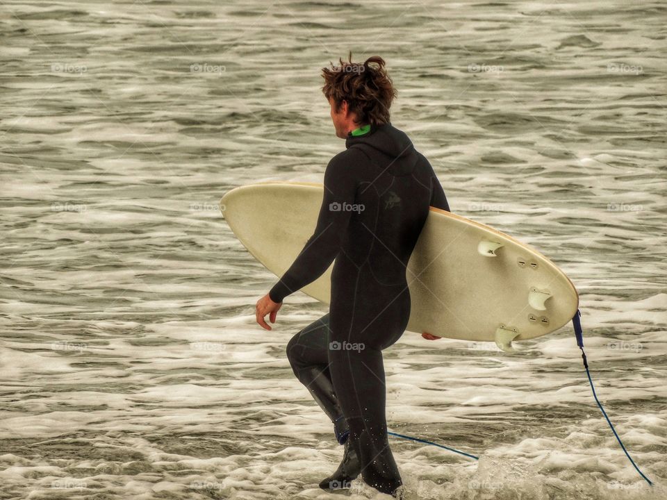 Surfer Entering The Waves