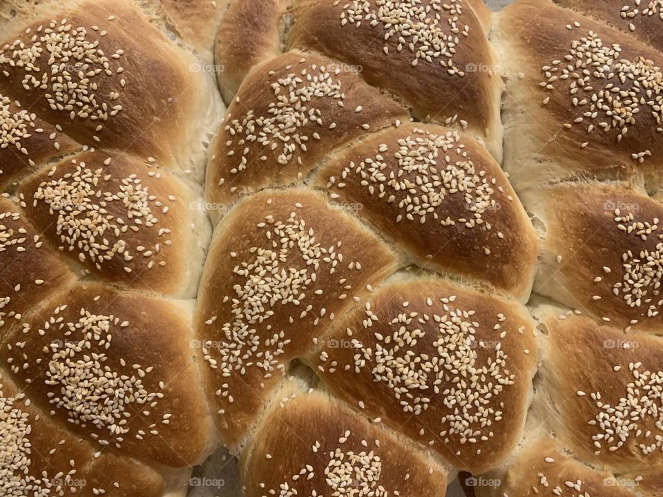 Chala bread with sesame seeds on top closeup