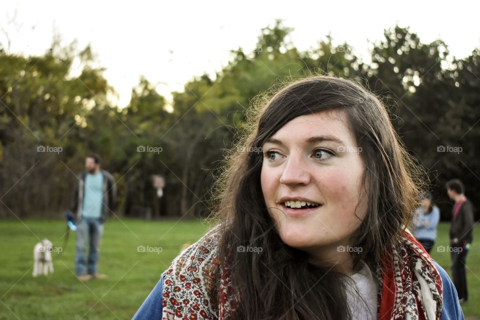 Beautiful millennial young woman having fun at dog park  