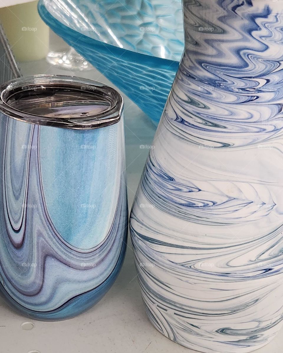 blue and white swirled artistic pattern containers with blue bowl on a store shelf