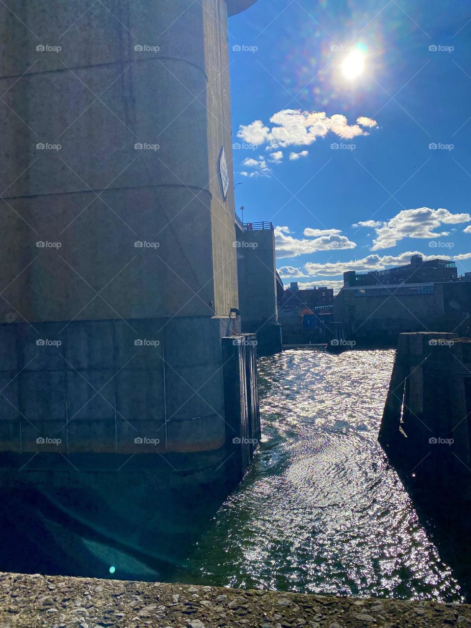 A view across the East River at Newtown Creek, LIC, Queens, NY towards the Greenpoint, Bklyn side on a clear bright sunny afternoon in October of 2021. The wood pilings are also visible at 25 ft distance from the Pulaski Bridge. Hypnotic Productions