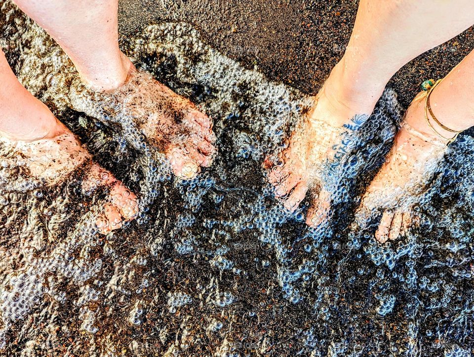 Bubbles and sandy feet in the sun.