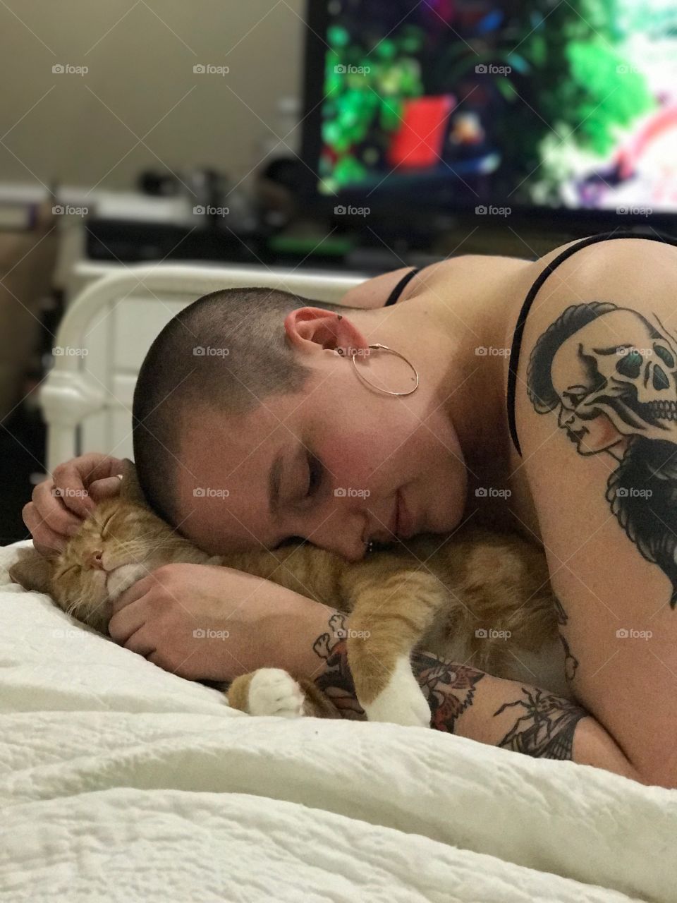 Woman lying on bed with cat