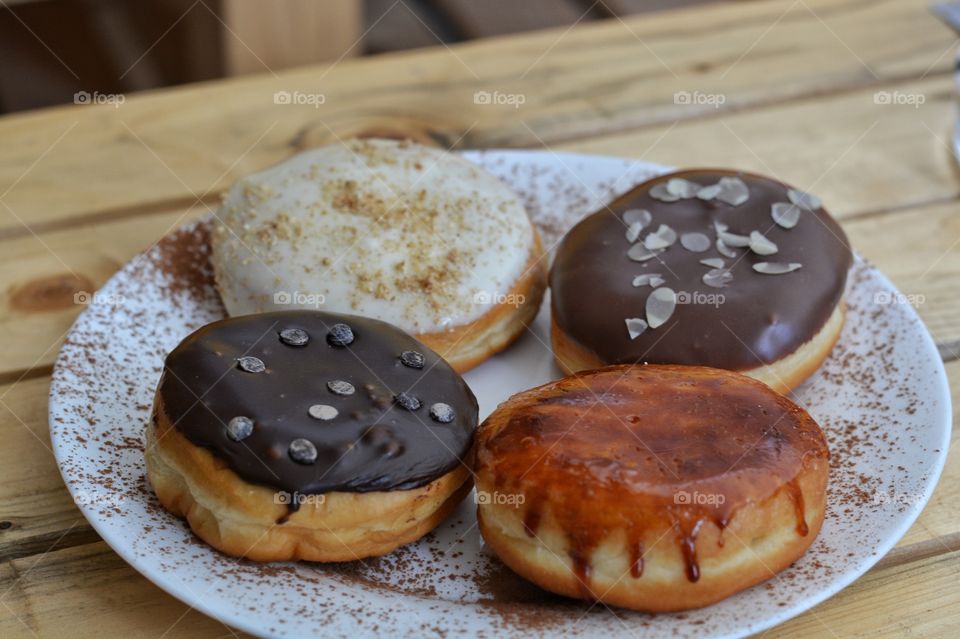 Delicious doughnuts with cream and chocolate