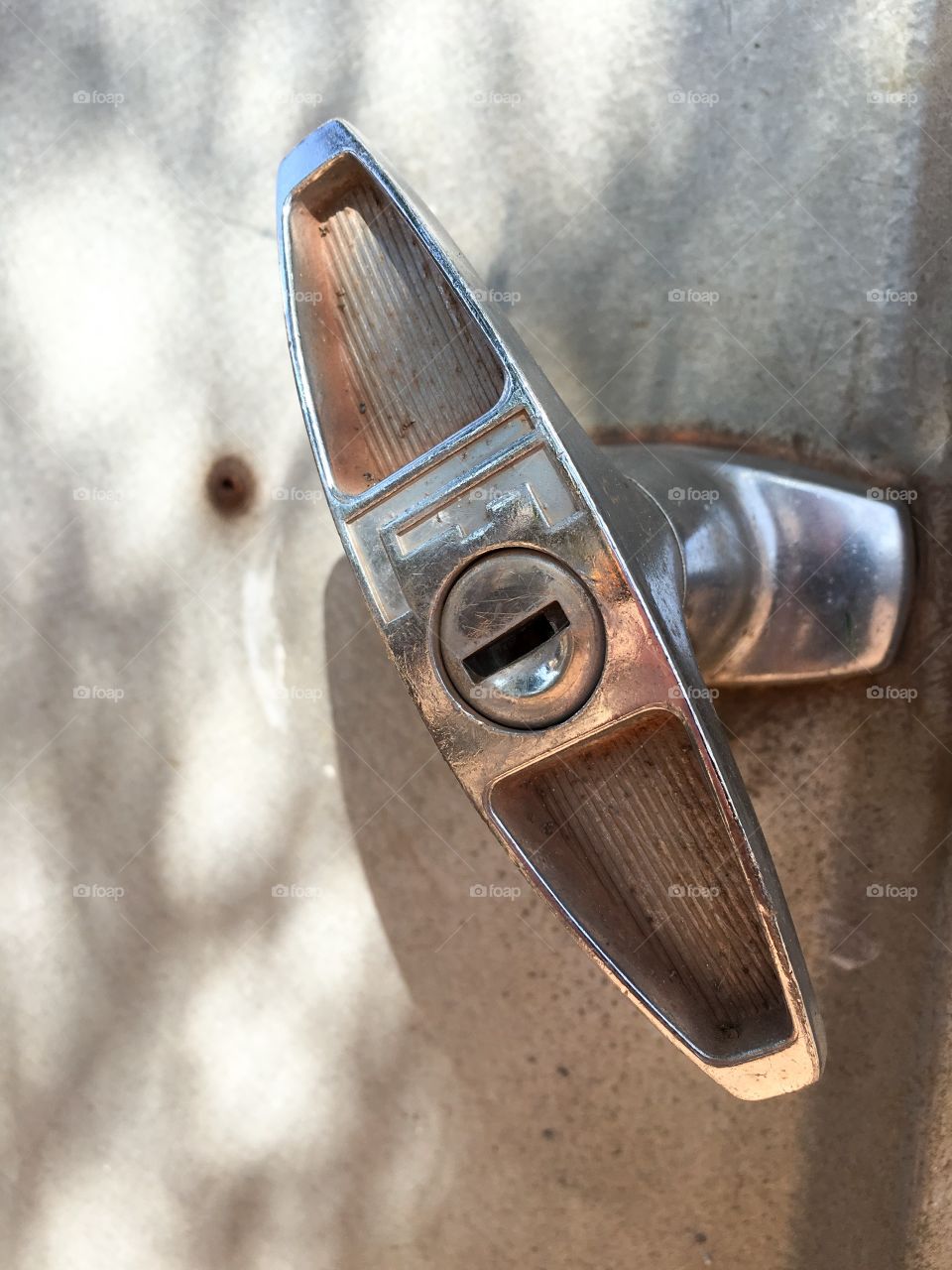 Stainless steel toggle door handle on aluminium shed door closeup