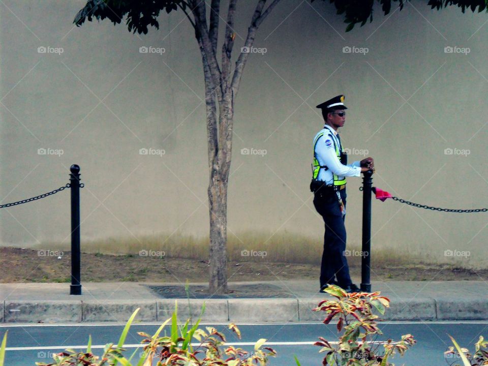 security guard standing by a sidewalk