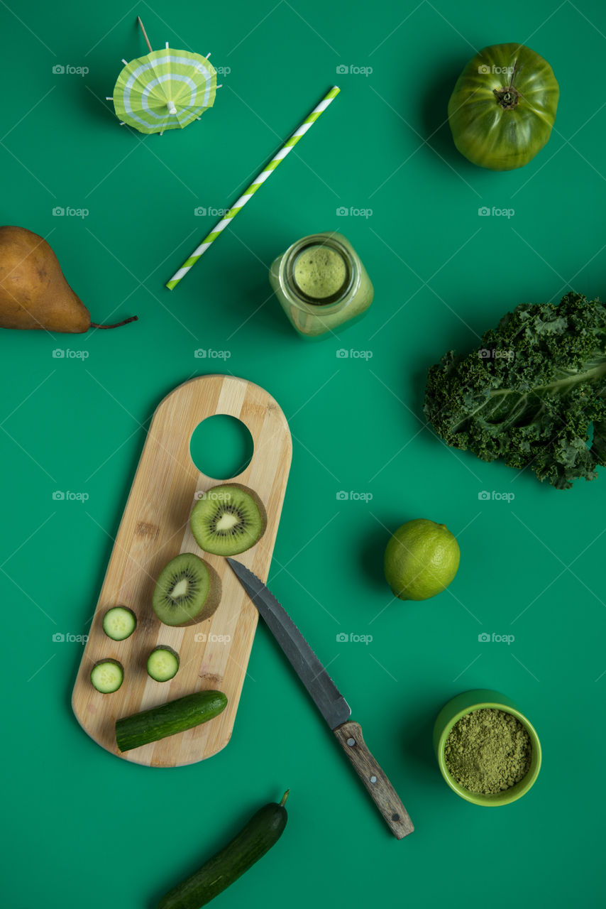 Monochromatic green flat lay of vegetable smoothie contents 