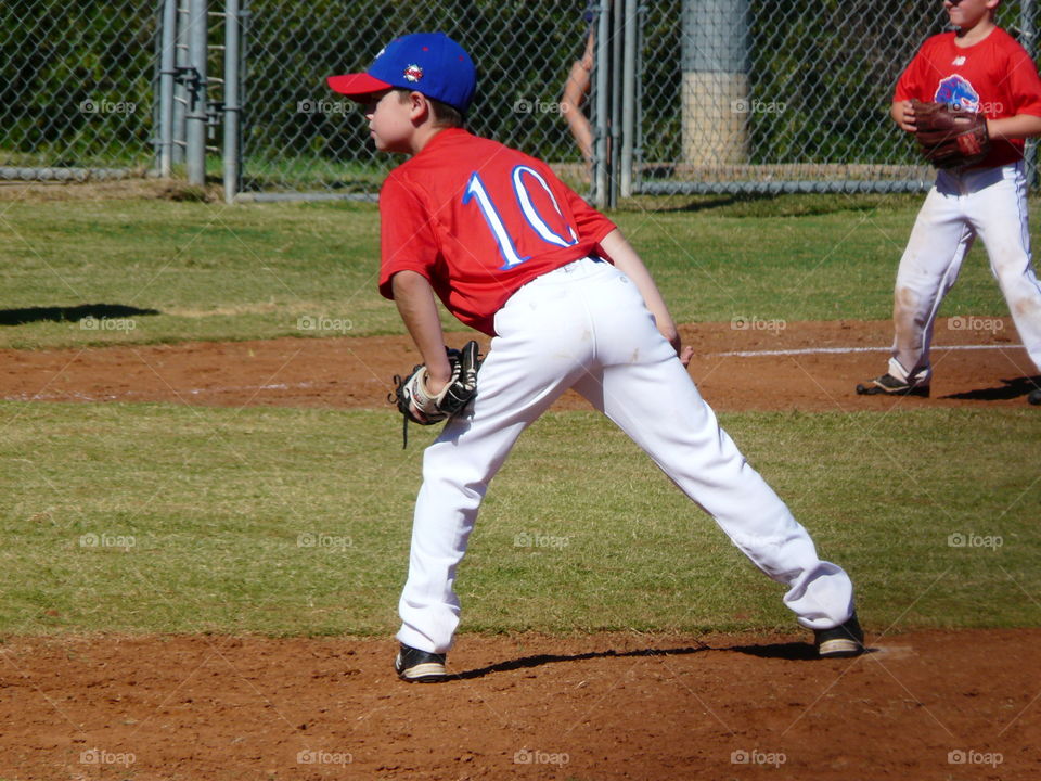 10 year baseball player. 10 year old baseball player. Pitcher getting his sign.