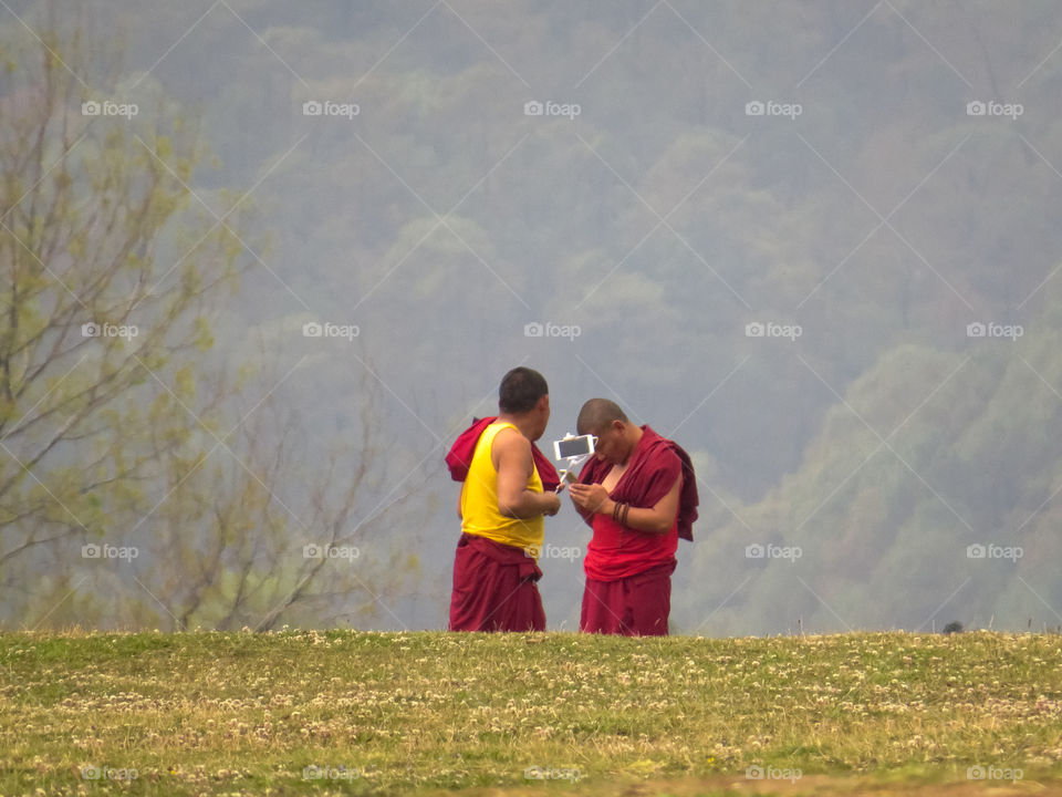 monk taking selfie and mobile phones