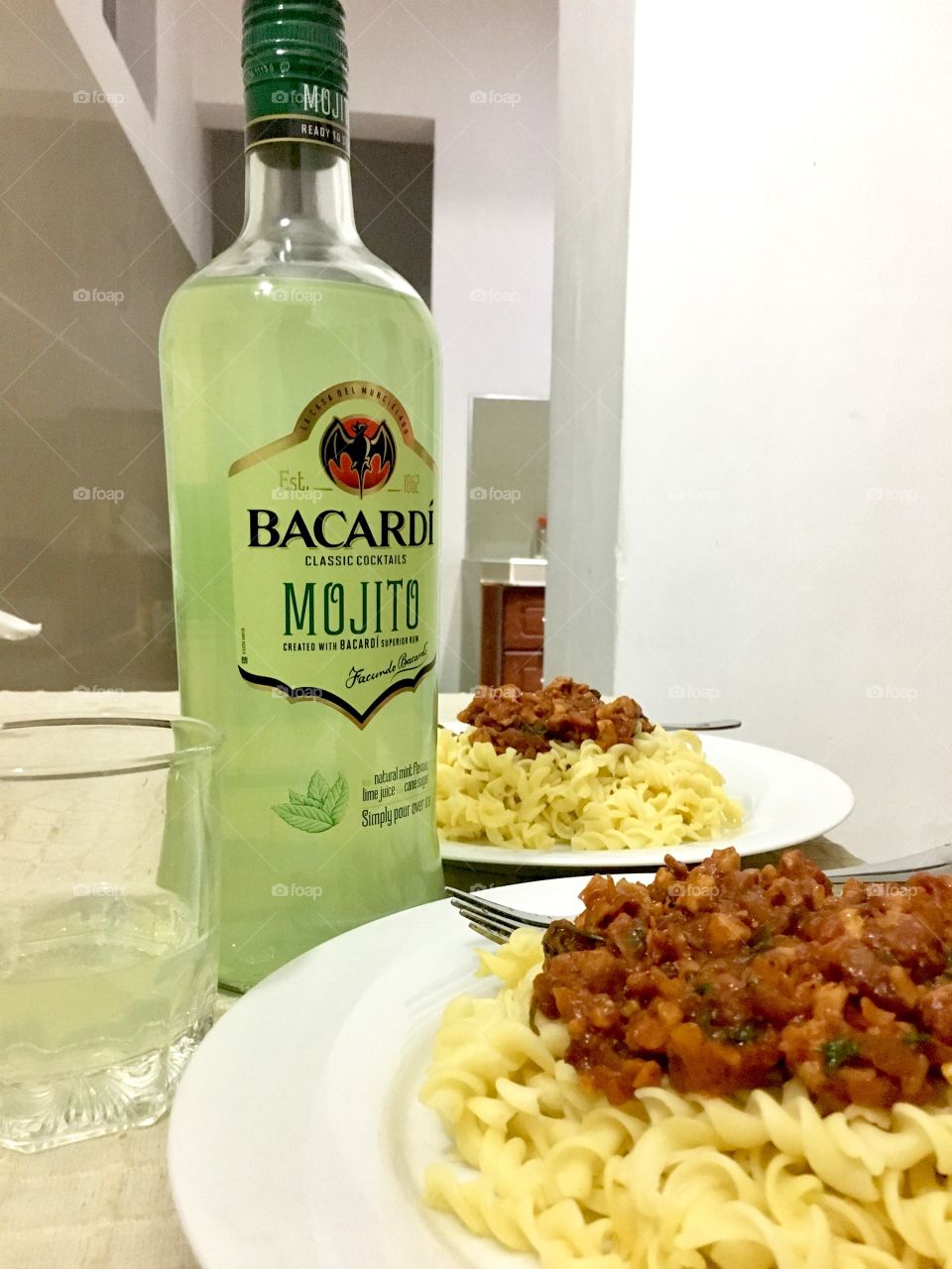 A Pasta Bolognese with a glass of Bacardi Mojito