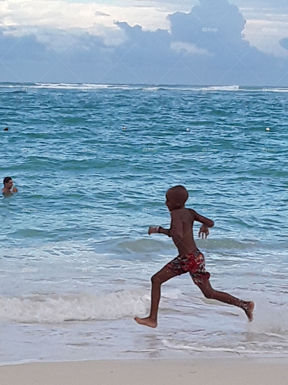 boy running on the beach