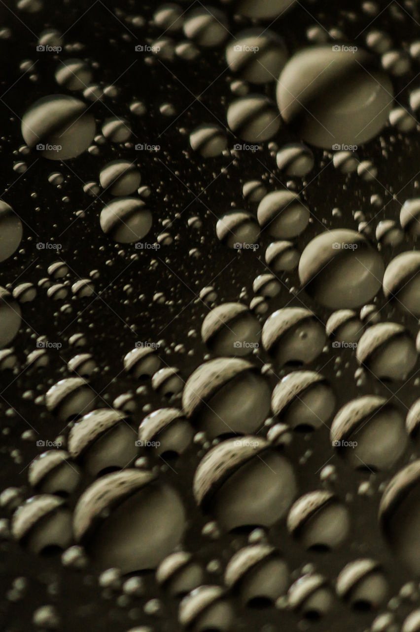 Small bubbles of vegetable oil in water close-up.