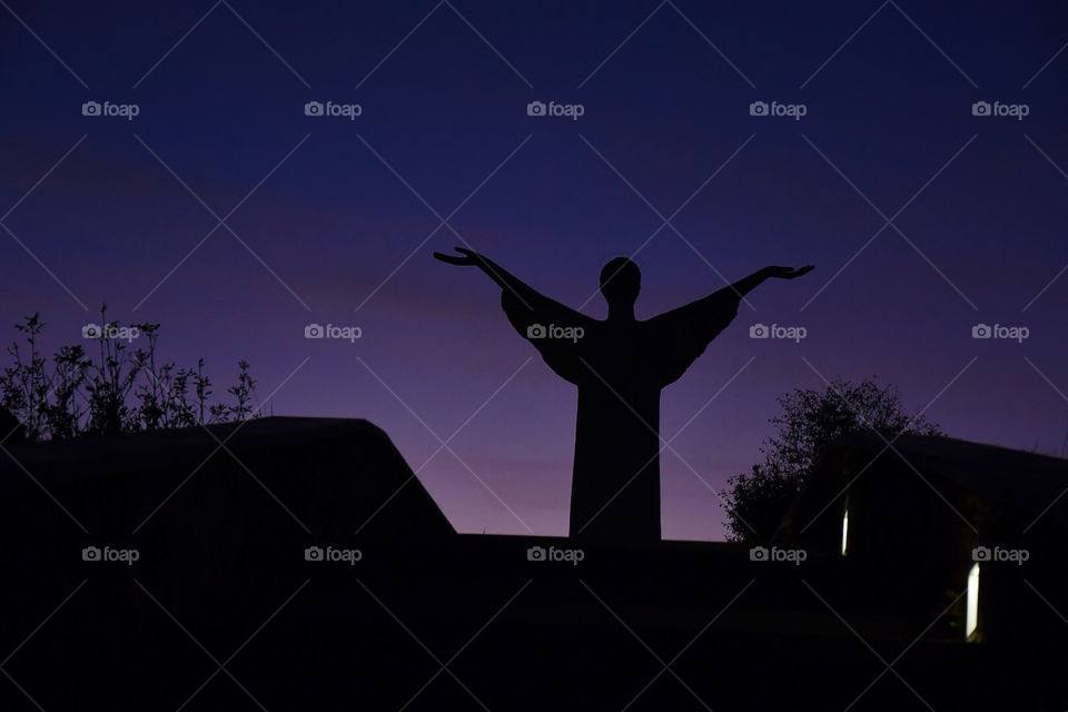 after sunset _ the blue hour _ Take place in Calabria ( Italy)  statue of Christ the Redeemer, Il Redentore. The 22-metre-high statue faces inland, arms outstretched to bless this historically impoverished part of southern Italy