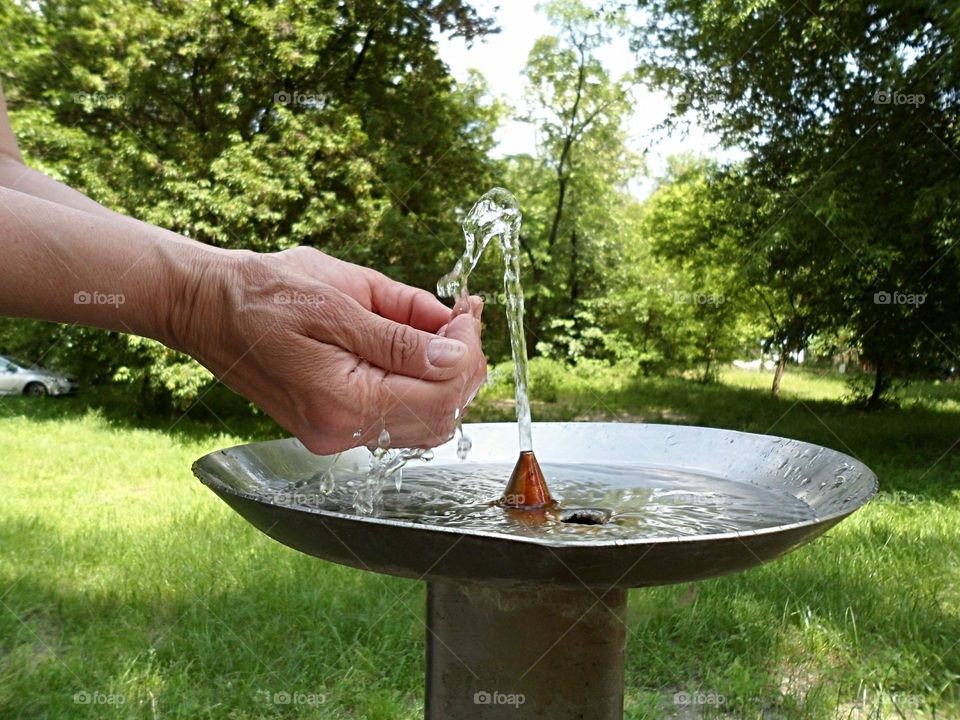 Hands and water fountain