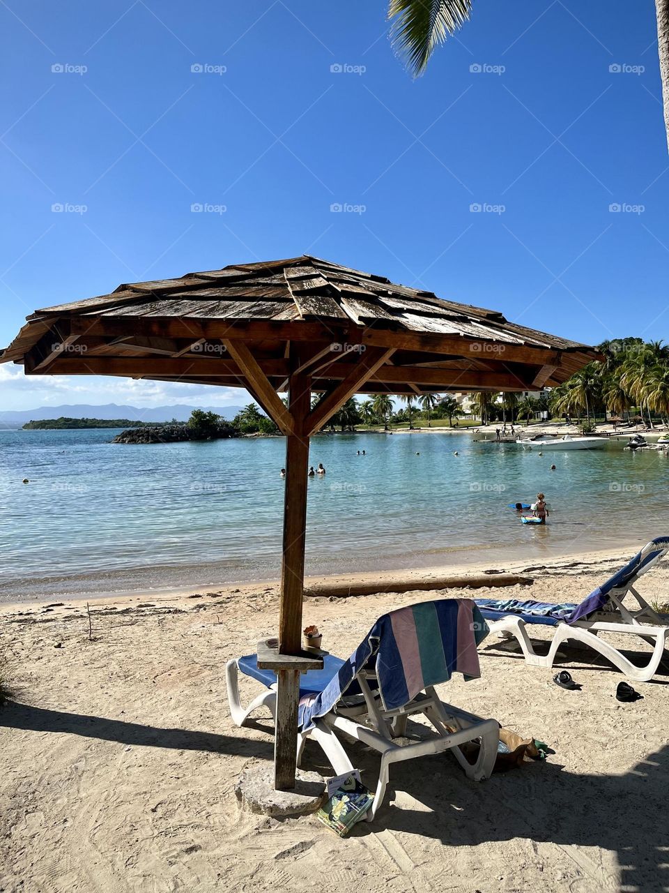 Parasol and chaise longue on the sand of a Caribbean beach