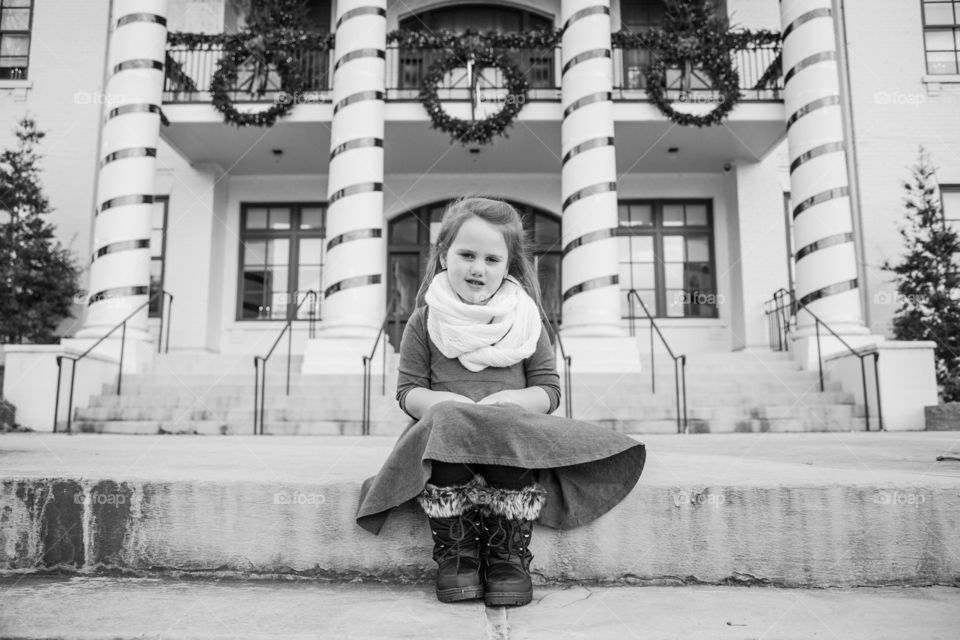 Little girl in front of Christmas columns