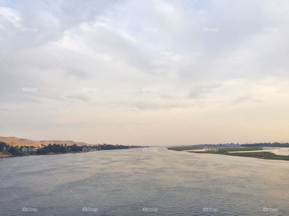 Nile river and mirrored sunset sky 