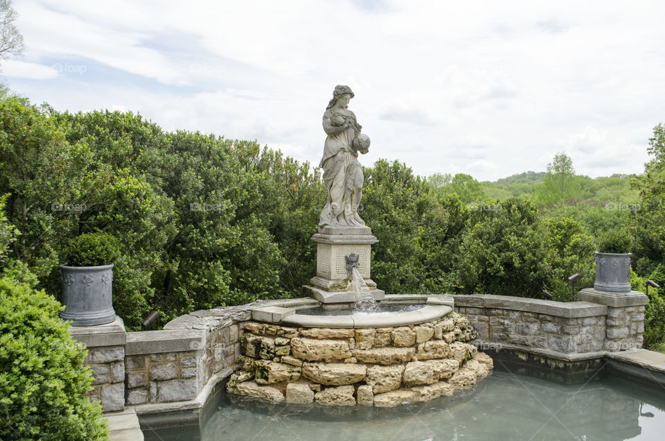 stone fountain . in the garden