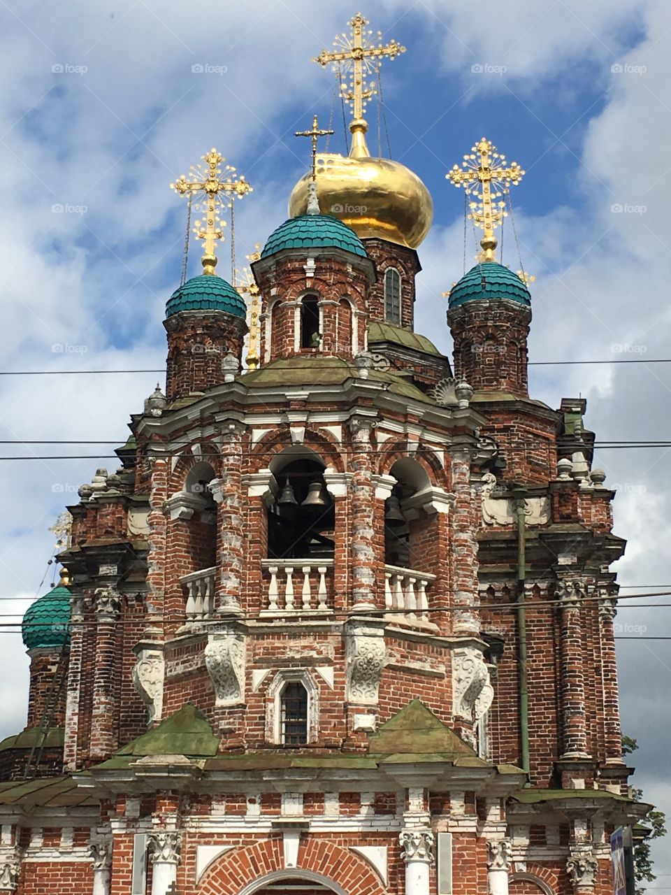 A large red Russian cathedral with domes and crosses