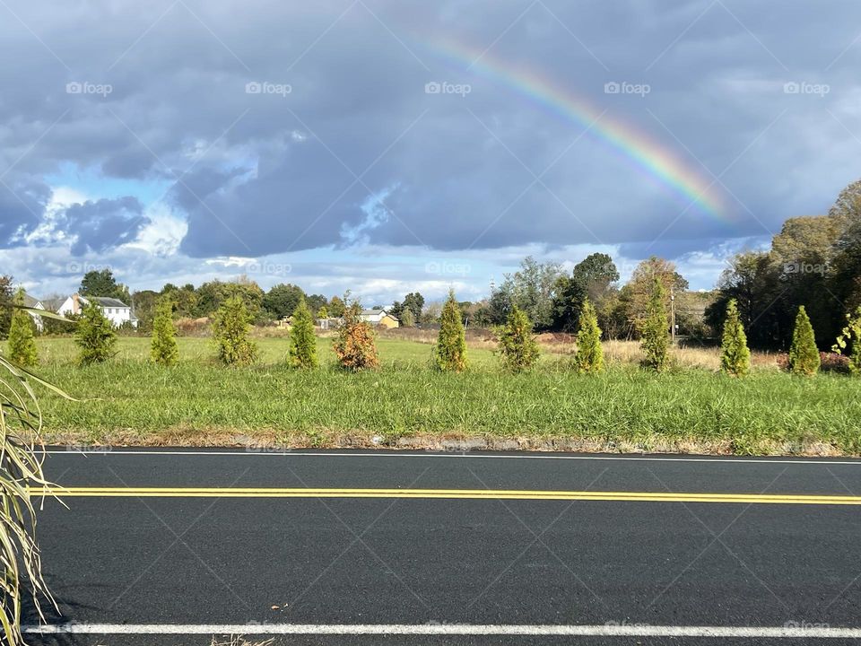 Fall season with rainbow in the sky