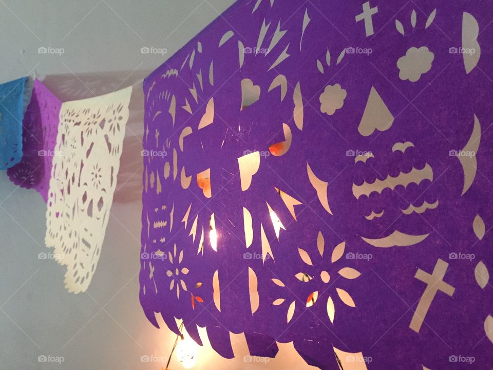 Papel picado (punched tissue paper) hung for Día de Muertos