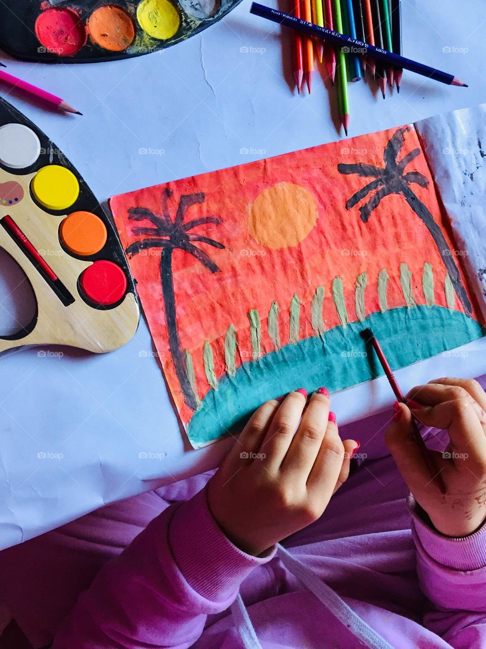 A little girl practicing her favorite hobby which is painting