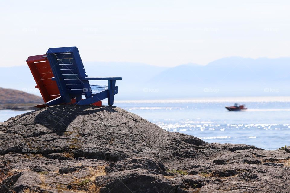 Lounge chairs on a rocky shore with a beautiful view