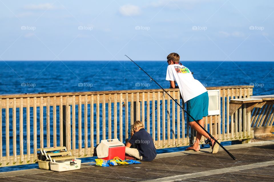 Men waiting for the fish while fishing at coast