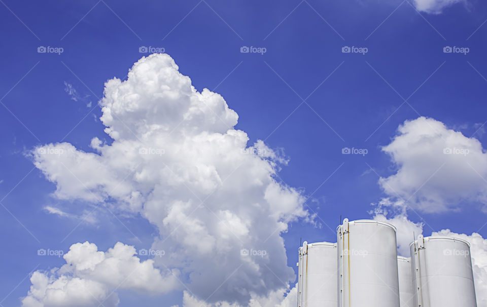 Fuel tanks White and The beauty of the sky with clouds and the sun in summer.