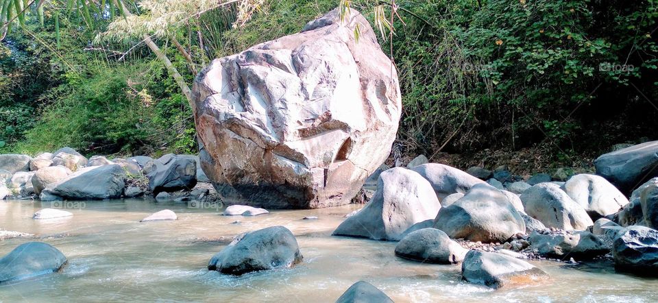 This big rock is in the middle of the river