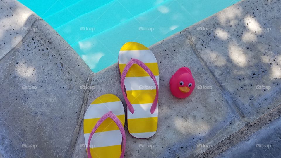 Flip flops and a pink duck