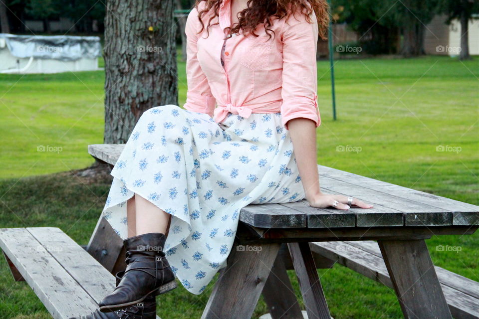 Close-up of a girl relaxing on the picnic table